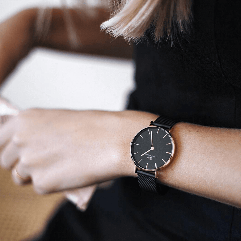 Petite Ashfield Rose Gold ladies watch with a black mesh strap and rose gold case, worn on a woman's wrist for a stylish, everyday look.