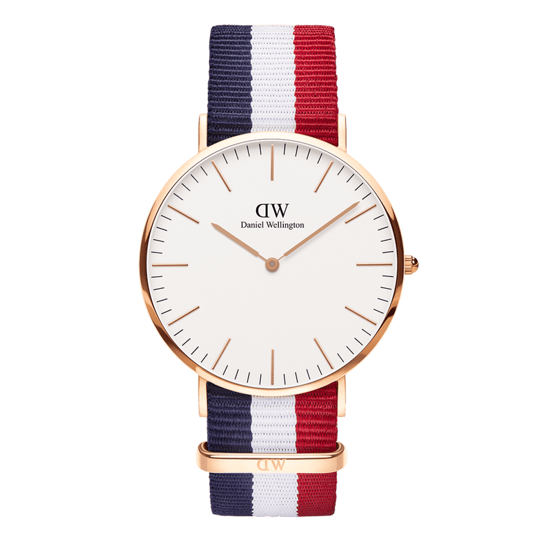 Classic Cambridge Rose Gold watch with a rose gold case, minimalist eggshell white dial, and an adjustable blue, white, and red striped NATO strap.