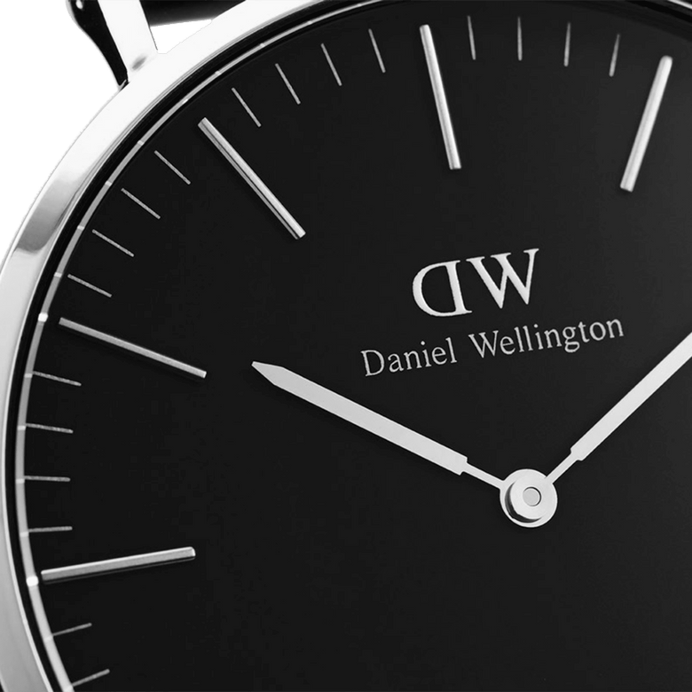 Close-up of the Classic Cornwall Black Silver watch showing the black dial, slim silver hands, and polished silver hour markers for a minimalist, elegant finish.