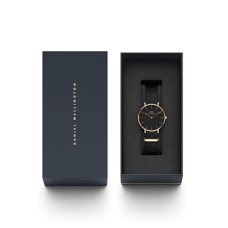 Petite Cornwall Black Rose Gold women’s watch with a black NATO strap and rose gold case, elegantly presented in a branded Daniel Wellington gift box.