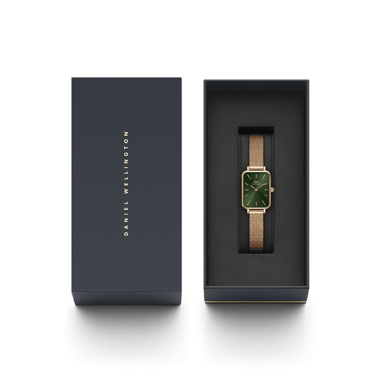 Quadro Pressed Melrose Emerald ladies watch with a rectangular emerald green dial and rose gold mesh strap, elegantly presented in a branded Daniel Wellington gift box.