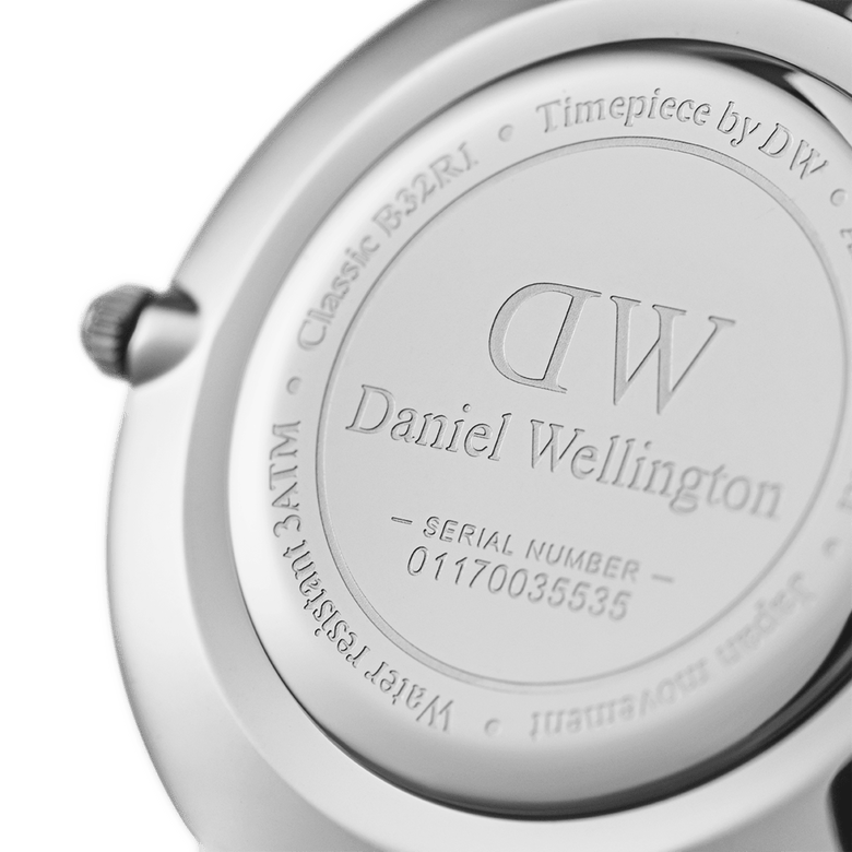 Close-up of the Petite Bondi Black Silver watch case back, showing the Daniel Wellington engraving, unique serial number, and water resistance details.