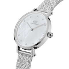 Petite Lumine Pressed Piano White MoP Silver ladies watch with a unique white mother of pearl dial, crystal hour markers, and a textured silver pressed Studio Strap, shown in a close-up angled view.