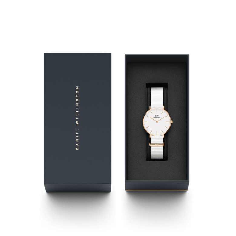 Petite Dover Rose Gold ladies watch with a white NATO strap and minimalist white dial, elegantly presented in a black Daniel Wellington gift box.