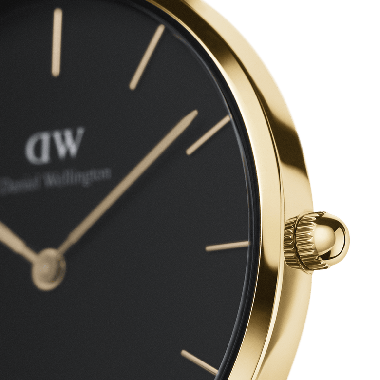 Close-up of the Petite St Mawes Black Gold watch showing the gold-plated stainless steel case, minimalist black dial, and gold hour markers for a sophisticated look.
