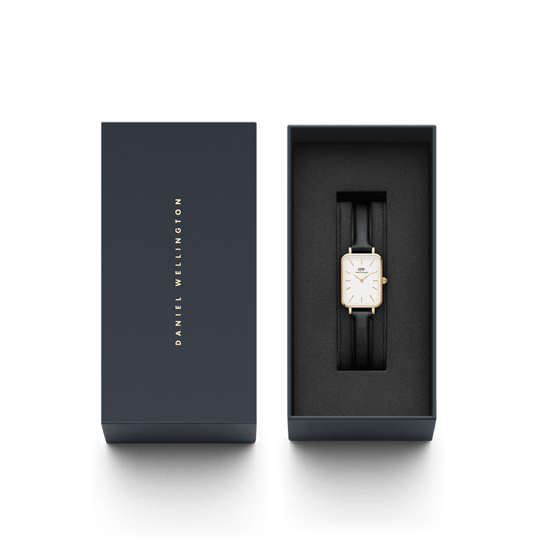 Quadro Pressed Sheffield Gold ladies watch with a rectangular gold case and black leather strap, elegantly presented in a branded Daniel Wellington gift box.
