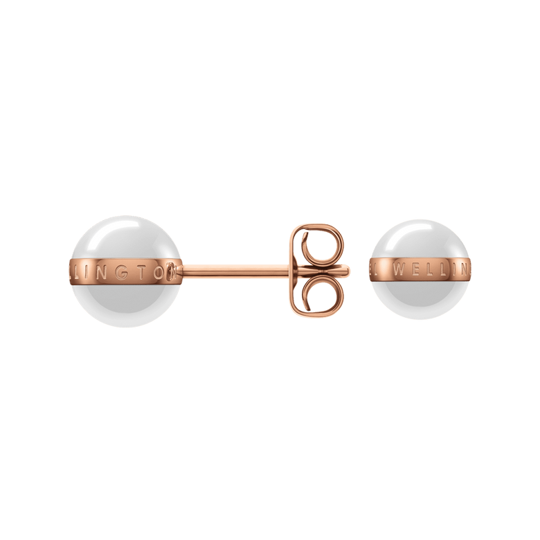 Aspiration Earrings Rose Gold Satin White shown with one earring displaying the secure rose gold stud fastening and both featuring smooth satin white ceramic spheres with a rose gold plated band engraved with branding.