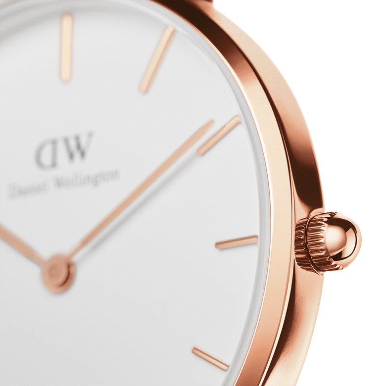 Close-up of the Petite Melrose Rose Gold watch showing the polished rose gold case, minimalist hour markers, and eggshell white dial with slim rose gold hands.