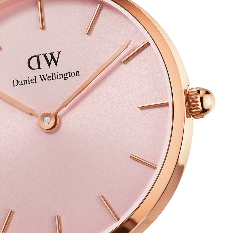 Close-up of the Petite Melrose Light Pink Rose Gold watch showing the soft pink dial, minimalist gold hour markers, and rose gold case with a smooth crown.