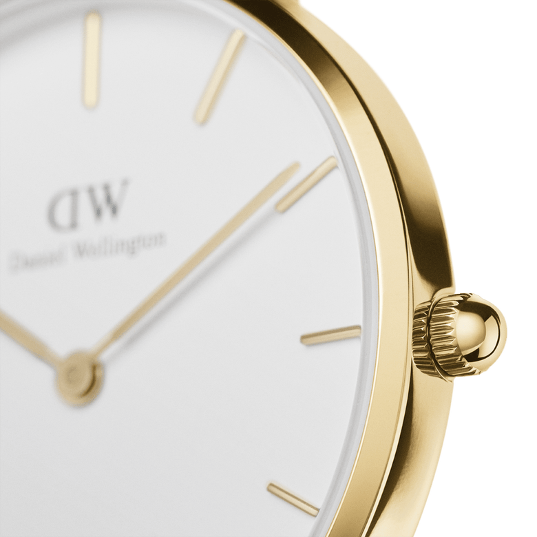 Close-up of the Petite Sheffield Gold watch showing the gold-plated case, minimalist white dial, and gold hour markers, highlighting the refined detailing and elegant finish.