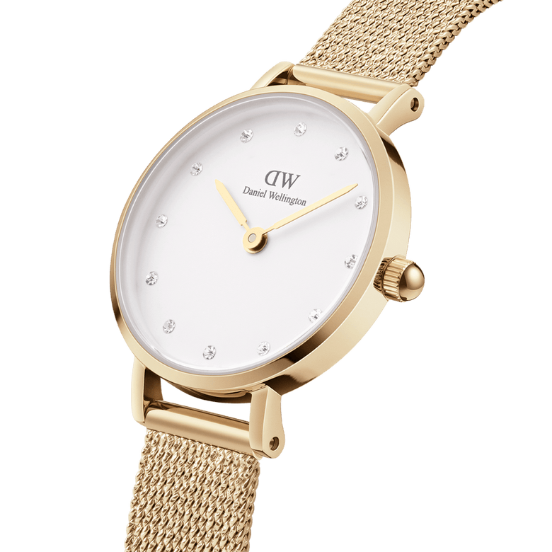 Petite Lumine Pressed Evergold gold mesh strap watch with a smooth eggshell white dial, crystal hour markers, and minimalist gold case, shown in a close-up to highlight its refined detailing and elegant finish.