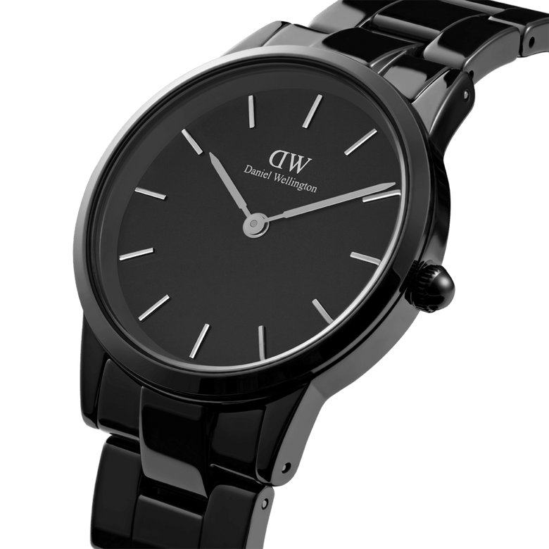 Close-up of the Iconic Link Ceramic watch showing its glossy black ceramic bracelet, minimalist black dial, and silver-tone markers, highlighting the refined finish and modern design.