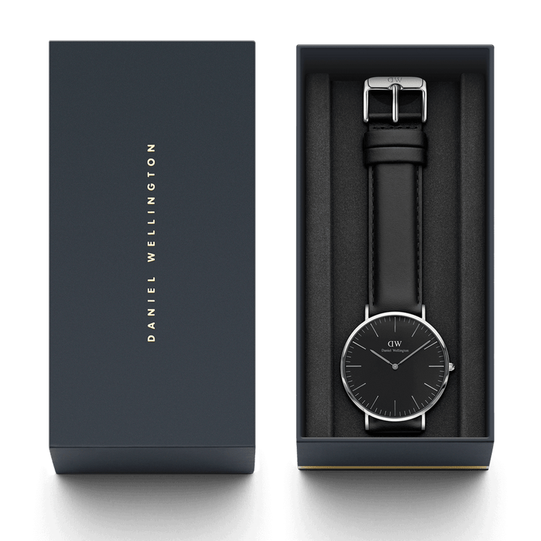 Classic Sheffield Black Silver watch presented in a Daniel Wellington branded gift box, featuring a minimalist black dial, polished silver case, and genuine black leather strap, ideal for gifting or special occasions.