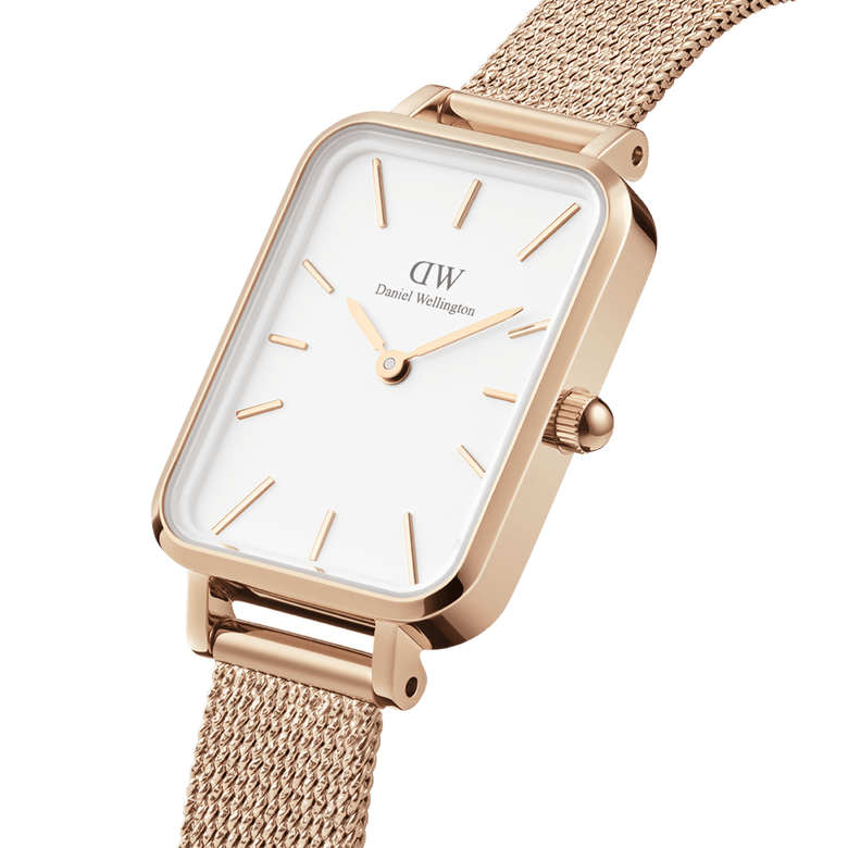 Close-up of the Quadro Pressed Melrose Rose Gold watch, highlighting its rectangular stainless steel case, minimalist white dial, and refined rose gold mesh strap.