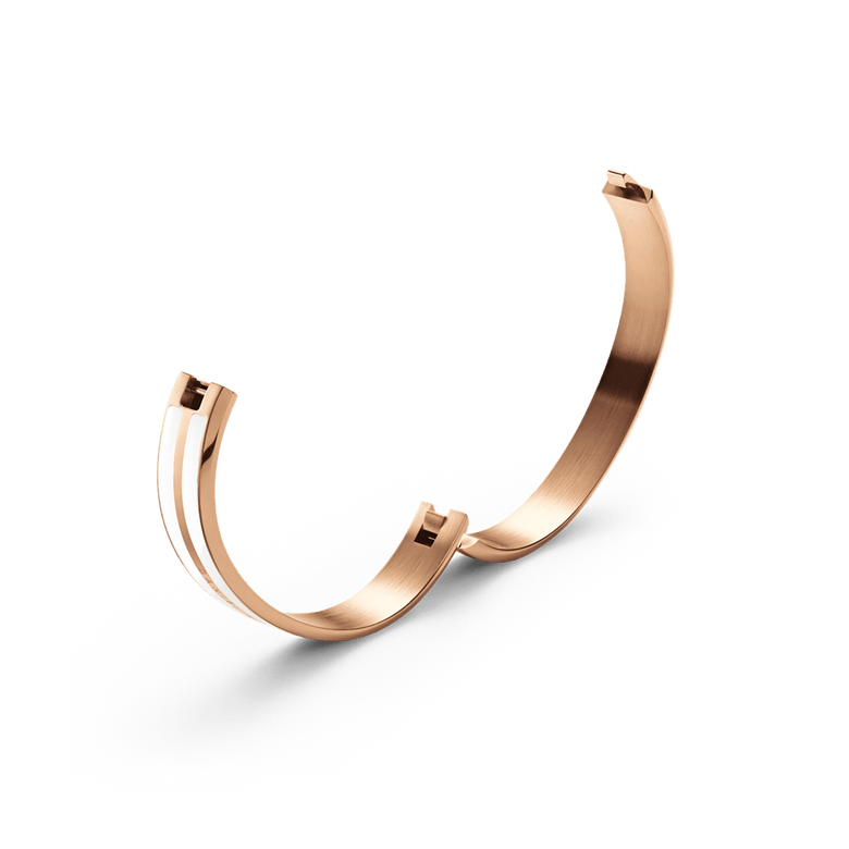 Emalie Infinite Rose Gold Satin White bangle shown open, highlighting its integrated closing system and polished rose gold finish with white enamel detailing.
