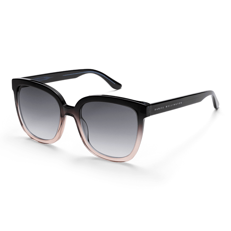 Grande Bio-Acetate Blue Coral Blue sunglasses by Daniel Wellington featuring an oversized square frame with a dark blue to coral gradient, black gradient UV400 lenses, and branded temples for a stylish and protective look.