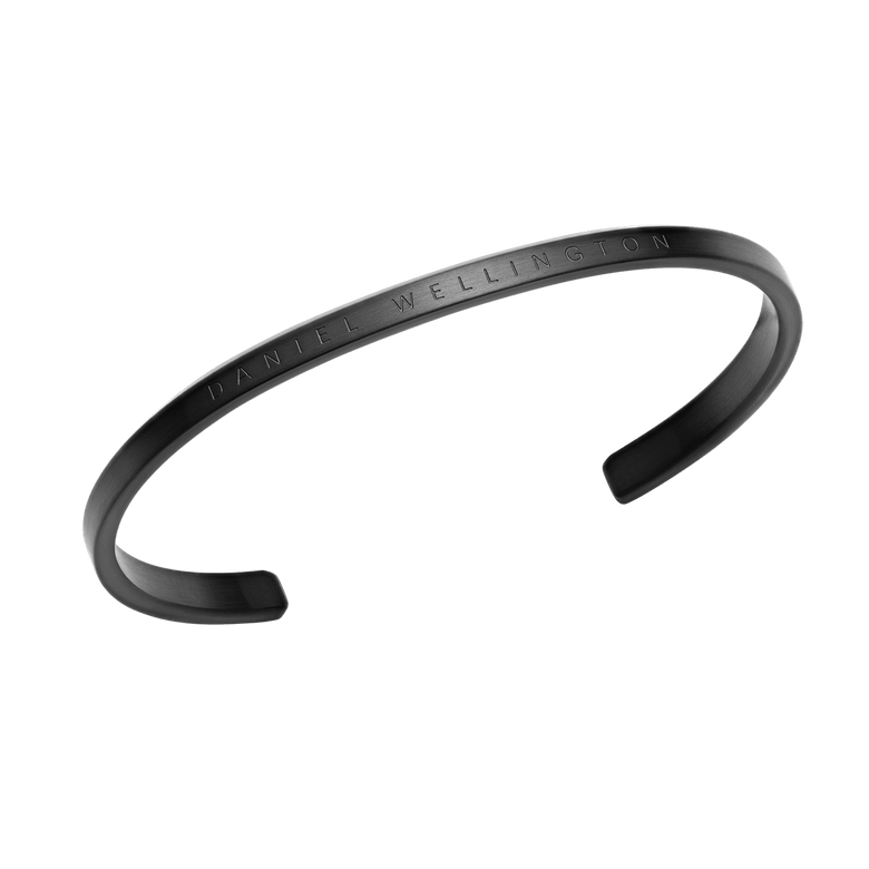 Classic Bracelet in matte black stainless steel with engraved Daniel Wellington branding, featuring a curved open cuff design and minimalist style for men and women.