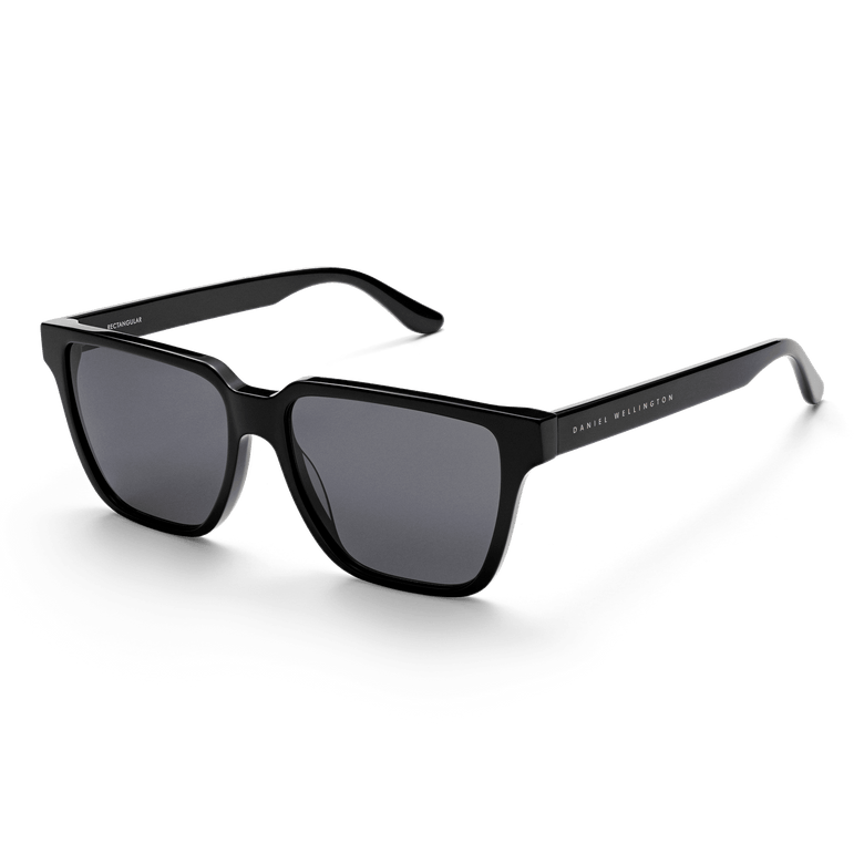 Rectangular Bio-Acetate Black sunglasses with a bold black oversized frame, UV400 nylon lenses, and Daniel Wellington branding on the temples, offering a stylish and contemporary look for men.