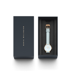 Petite Bluebell ladies watch with a pastel blue leather strap and rose gold case, presented in a sleek Daniel Wellington gift box.