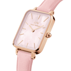 Close-up of the Quadro Cherry Blossom watch showing its rose gold rectangular case, pastel pink leather strap, and genuine mother of pearl dial with minimalist gold hour markers.