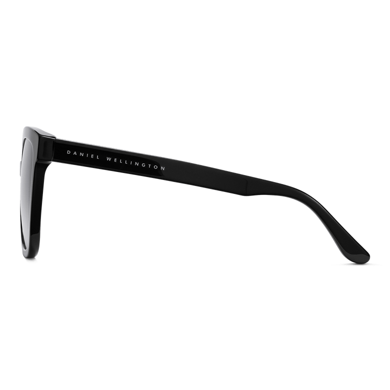 Side view of Grande Bio-Acetate Black Blue sunglasses showing the sleek black acetate frame and Daniel Wellington branding on the arm.